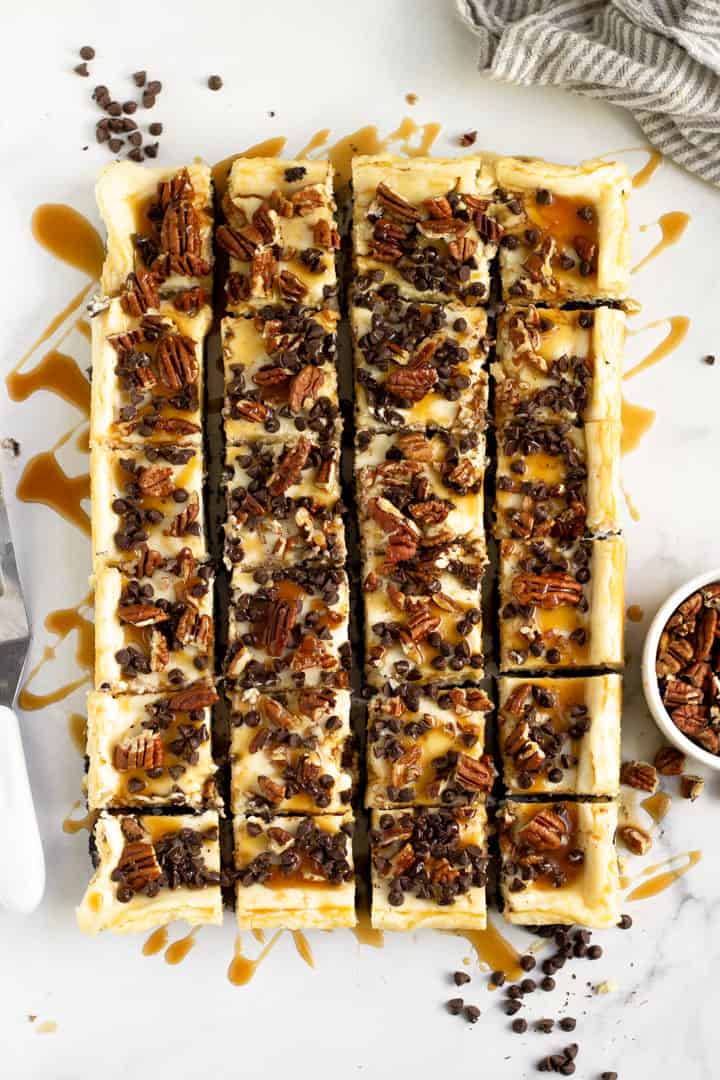 Overhead shot of turtle cheesecake bars cut into squares