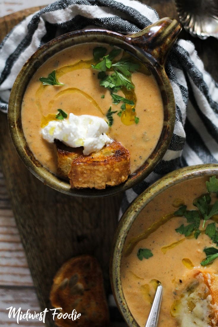 Roasted Tomato Soup -- Classic flavors of roasted tomato, onion and garlic combine with basil pesto and cream and give you the perfect tomato soup to dunk your grilled cheese! #midwestfoodie #vegetarian #quick #simple #easy #mealprep #recipe