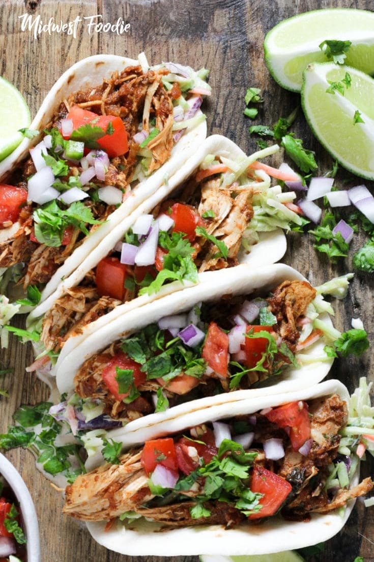 Healthy Slow Cooker Chicken Tacos | These slow cooker chicken tacos are healthy, tasty and almost too easy to make! Toss everything in the crock pot, come back a few hours later, shred the chicken and you're ready to sit down for dinner. I like to serve these tacos with my famous chipotle slaw because the crunchy veggies just compliment the shredded chicken so well. #midwestfoodie #tacos #mealprep #simple #recipe