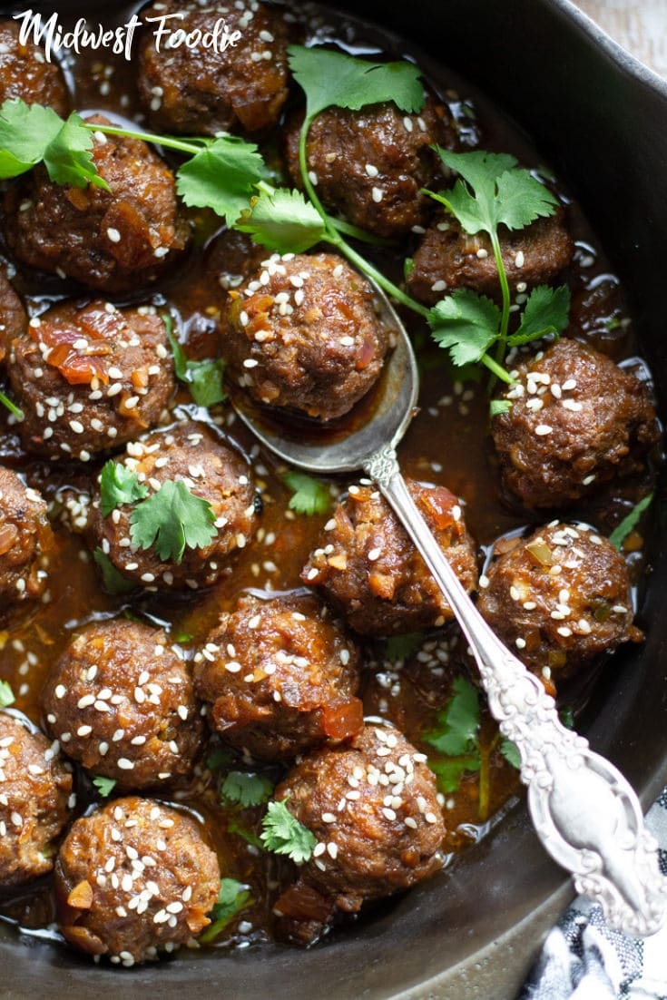 Baked Korean Beef Meatballs | Midwest Foodie | Quick and easy hand rolled, homemade baked meatballs simmered in a flavor forward Korean inspired sauce. Serve with brown rice for dinner or with toothpicks as a tasty appetizer at your next party! #midwestfoodie #party #appetizer