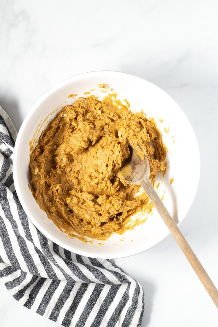 Overhead shot of a white bowl filled with peanut butter mixture for peanut butter balls
