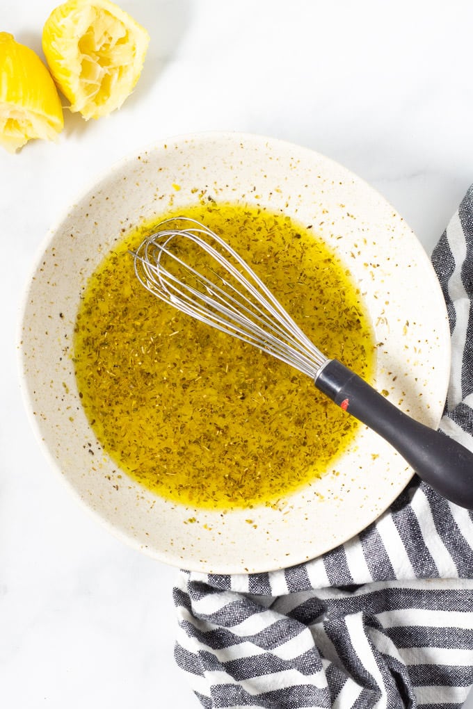 A bowl filled with marinade for Greek chicken kebabs