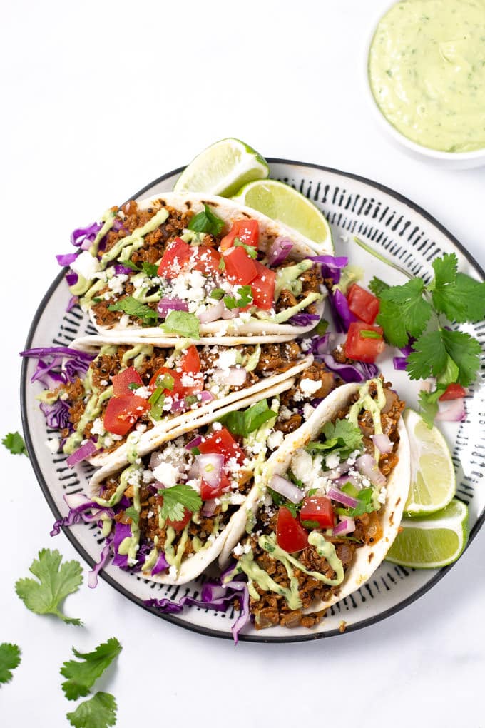 Plate filled with vegan tacos garnished with fresh cilantro