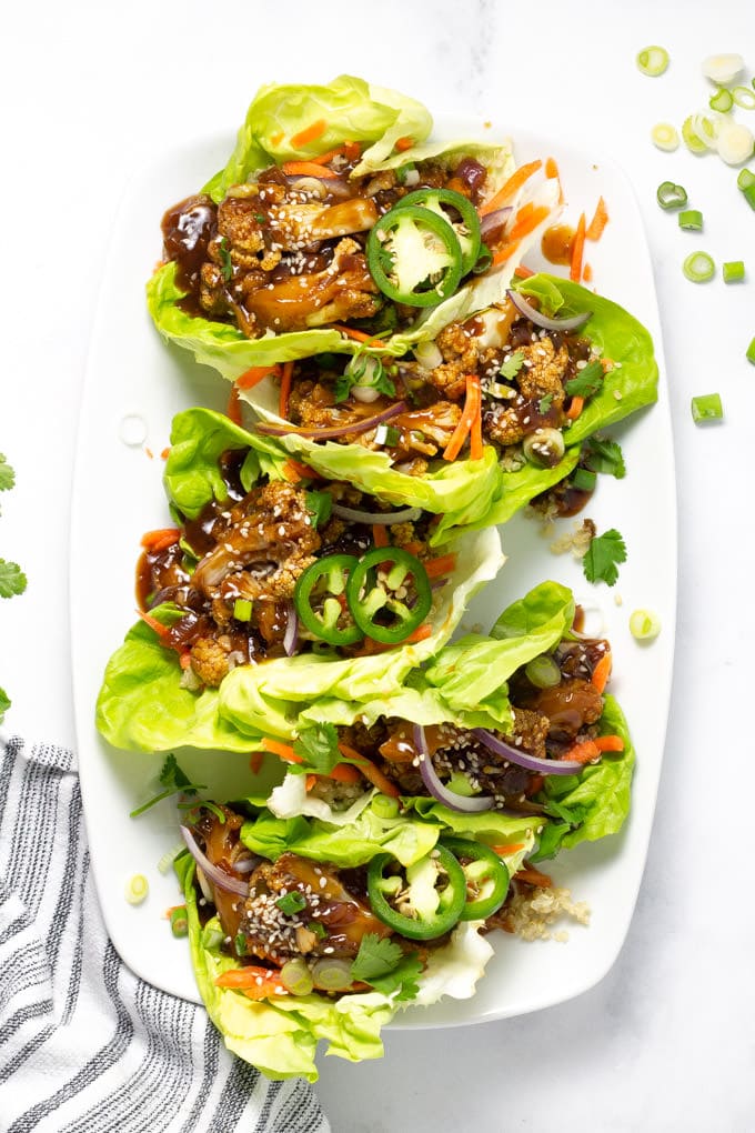 Overhead shot of Korean Cauliflower Lettuce Wraps on a white serving platter
