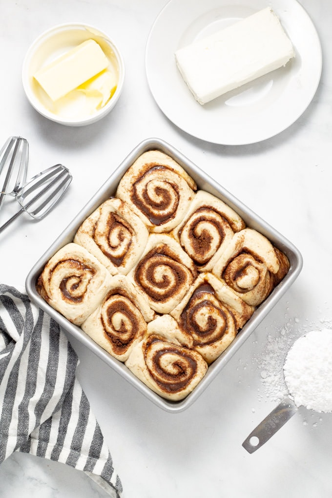 Overhead shot of cinnamon rolls rising in a pan