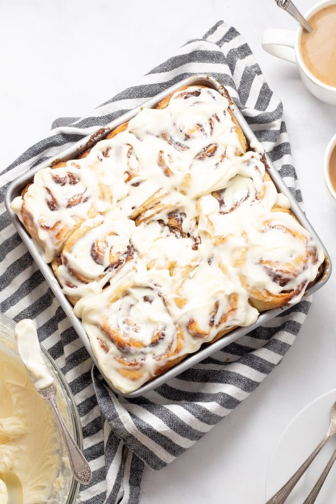 A big pan of homemade cinnamon rolls with cream cheese frosting