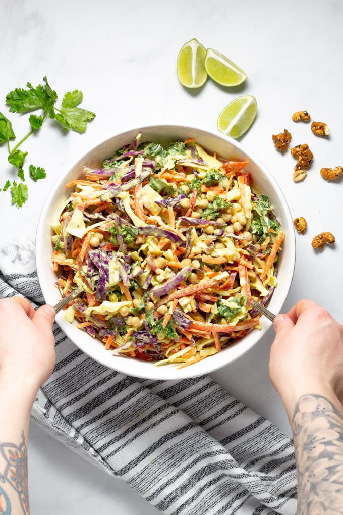 Overhead shot of curry slaw garnished with fresh cilantro and lime