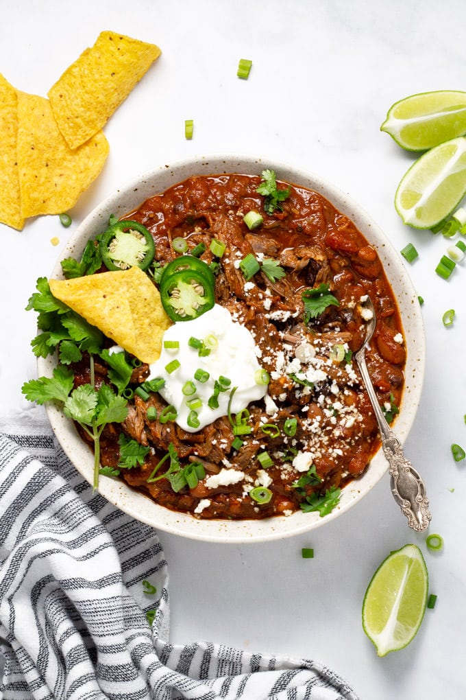 Overhead shot of a bowl of short rib chili garnished with fresh cilantro