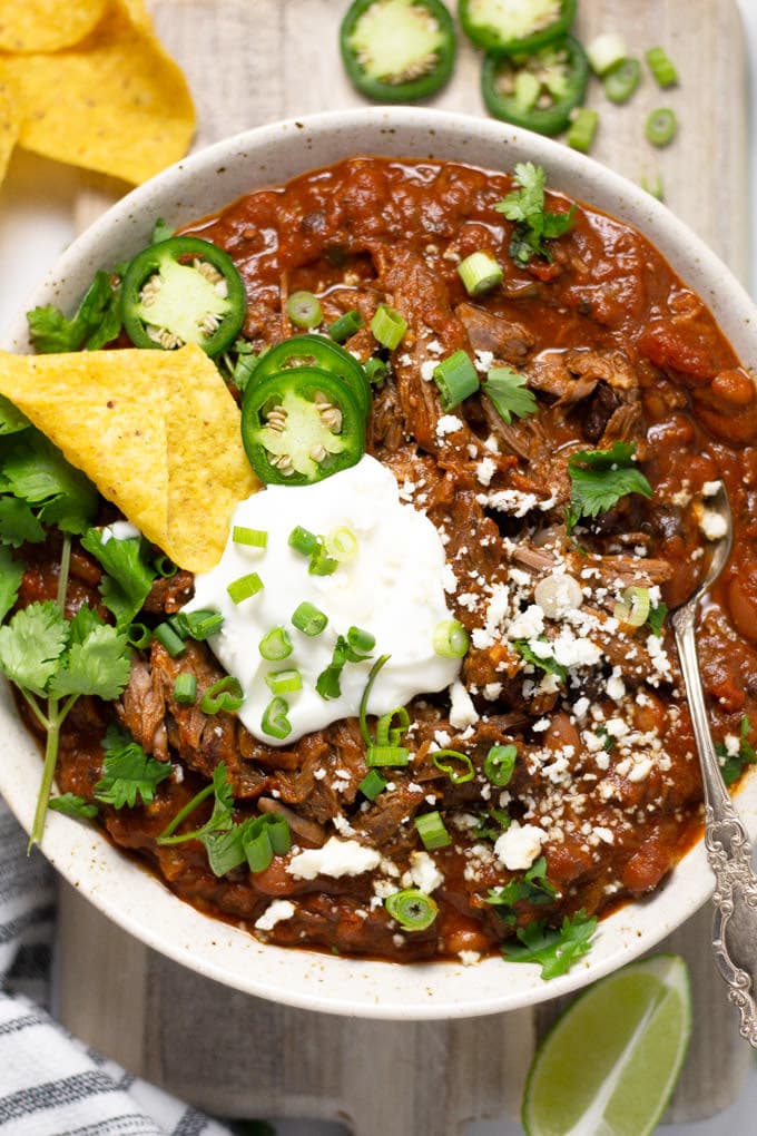 Overhead shot of a bowl of short rib chili garnished with fresh cilantro