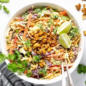 Overhead shot of curry slaw garnished with fresh cilantro and lime