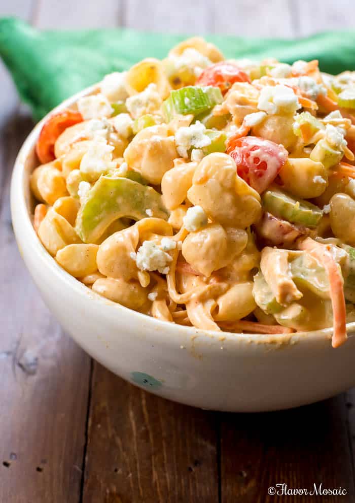 Close up shot of a white bowl filled with buffalo chicken pasta salad