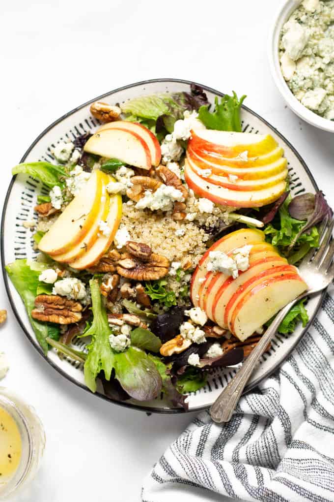 Close up shot of apple pecan salad with crumbled Gorgonzola and quinoa