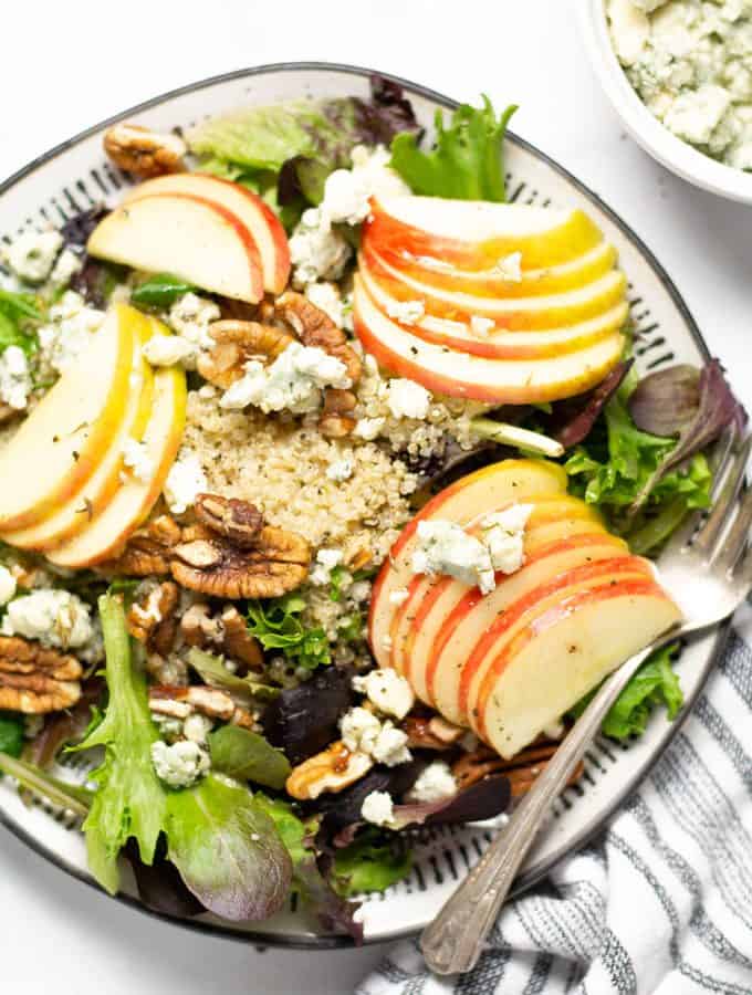 Overhead shot of a sliced apple salad with Gorgonzola cheese