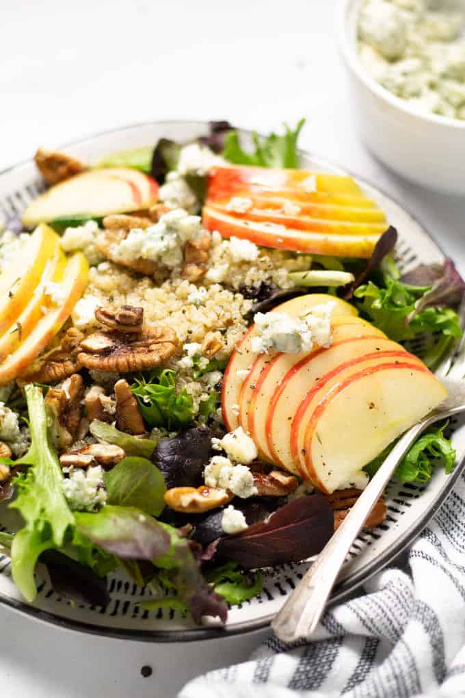 Close up shot of apple pecan salad with crumbled Gorgonzola and quinoa