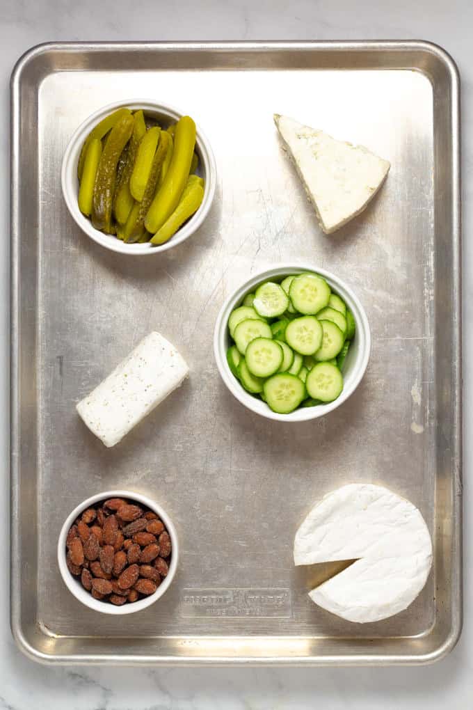 Overhead shot of a baking sheet filled with meat and cheese creating a cheese board