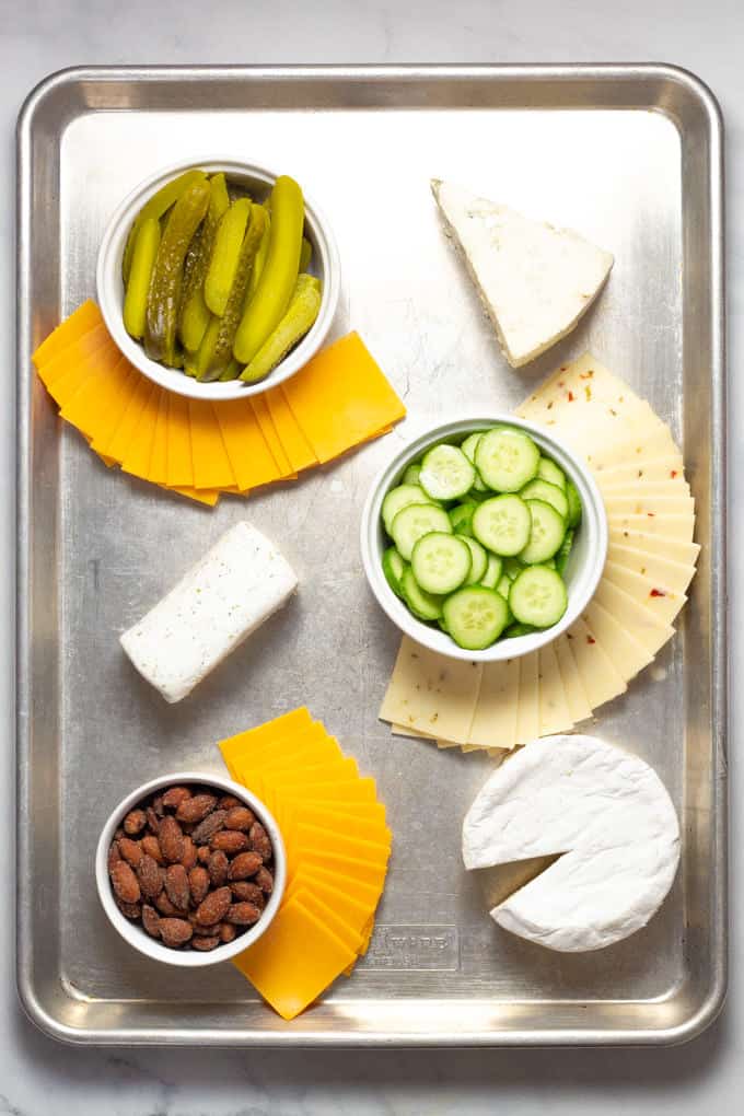 Overhead shot of a baking sheet filled with meat and cheese creating a cheese board