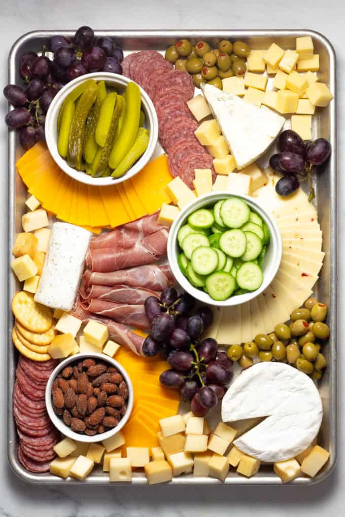 Overhead shot of a baking sheet filled with meat and cheese creating a cheese board