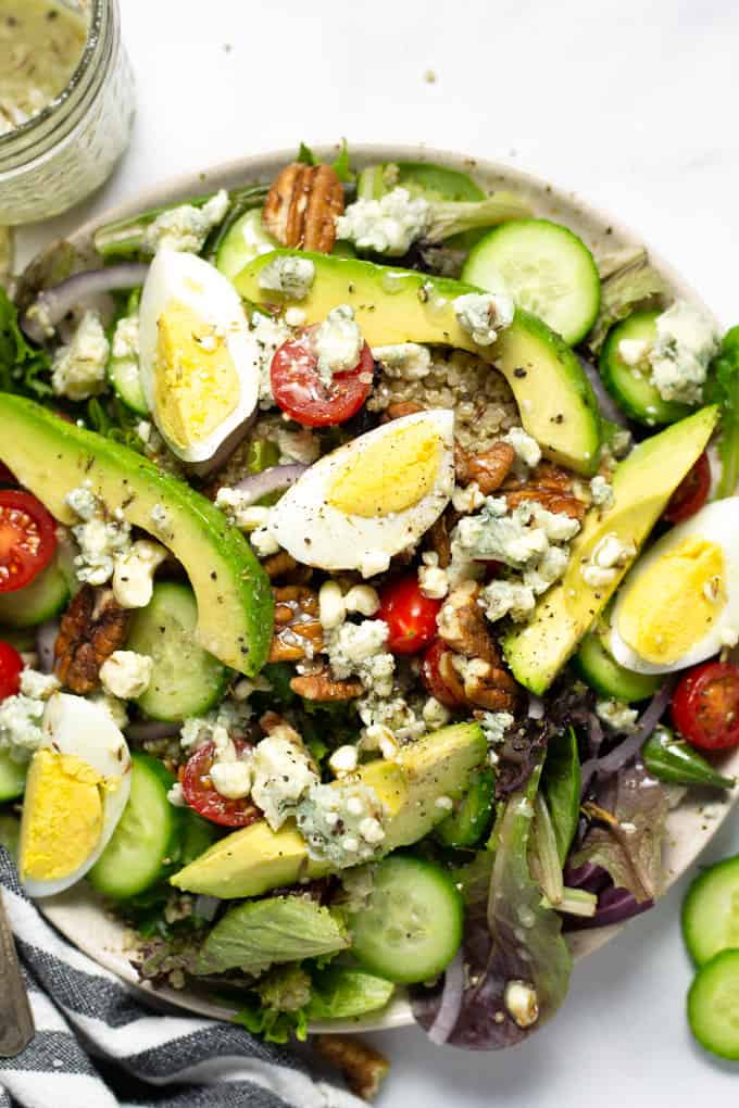 Close up shot of a fresh cobb meal prep salad drizzled with Gorgonzola dressing
