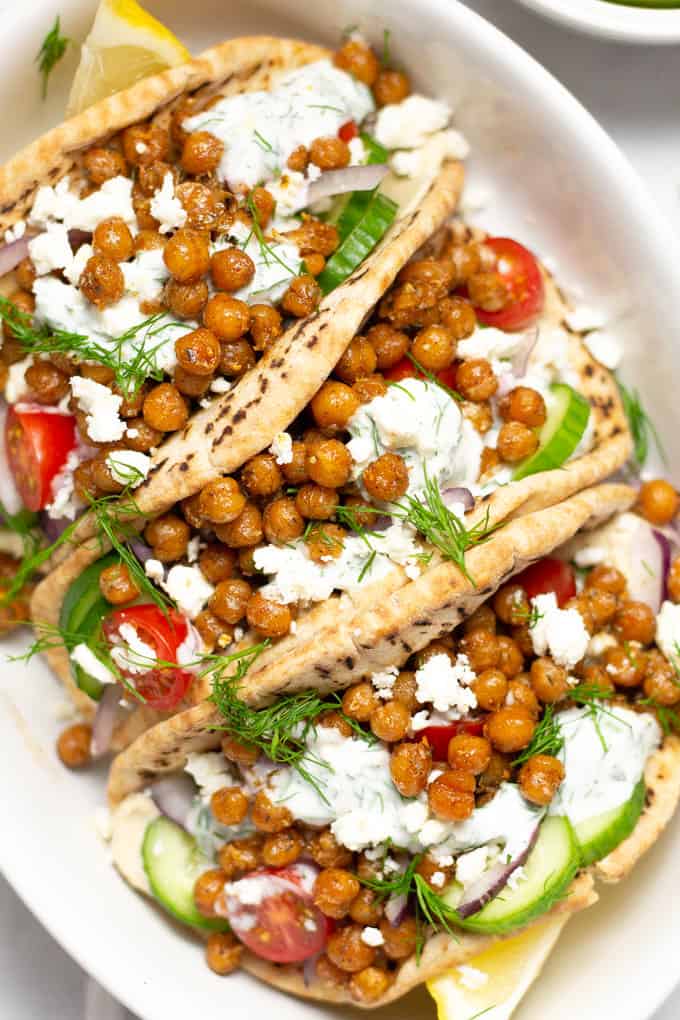 Overhead shot of a platter filled with chickpea gyros garnished with fresh dill