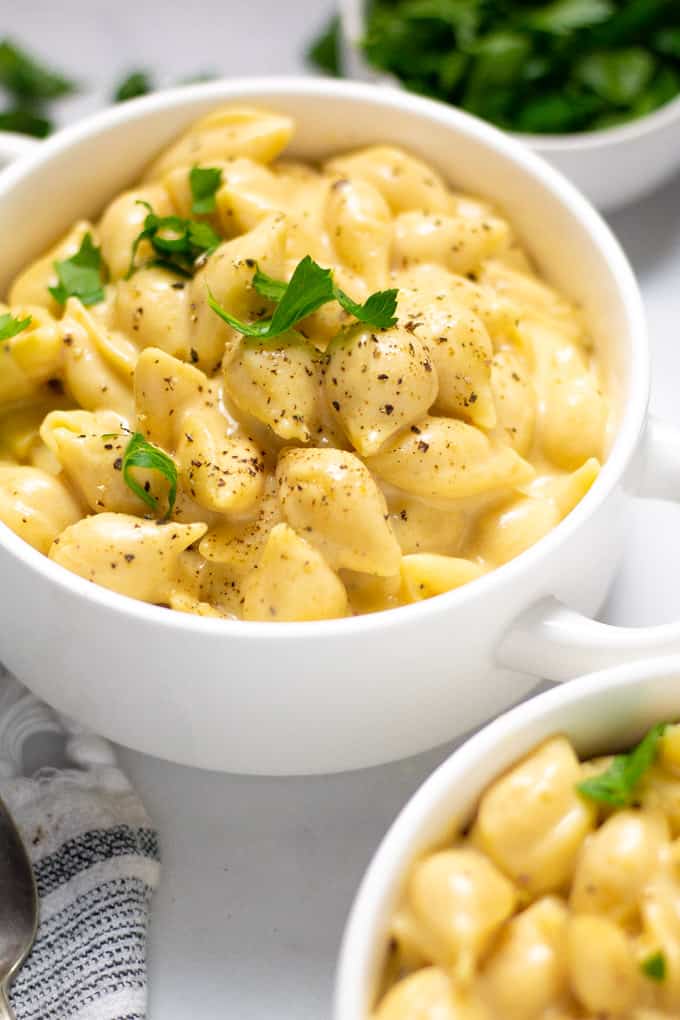 Close up shot of a white bowl filled with macaroni and cheese