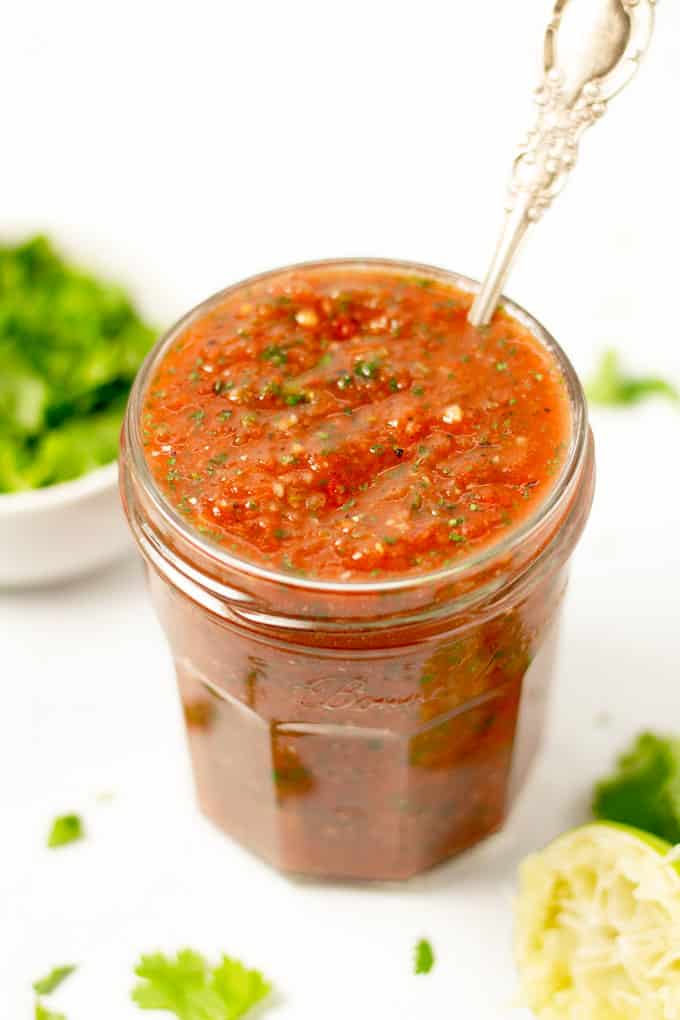 Close up shot of a jar filled with fresh homemade salsa