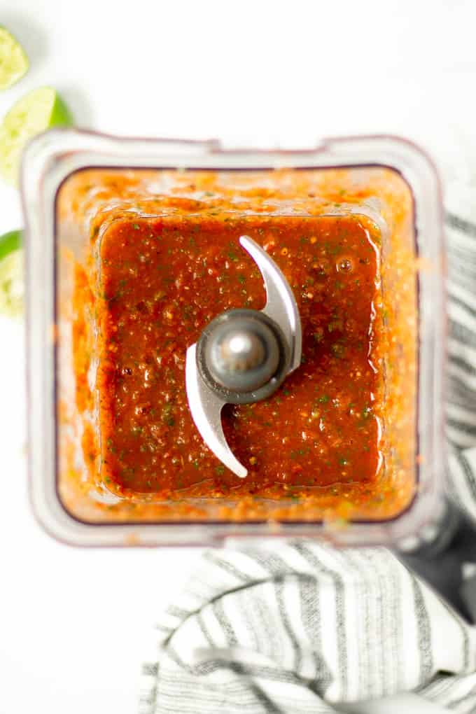 An overhead shot of a blender filled with fresh restaurant style blender salsa