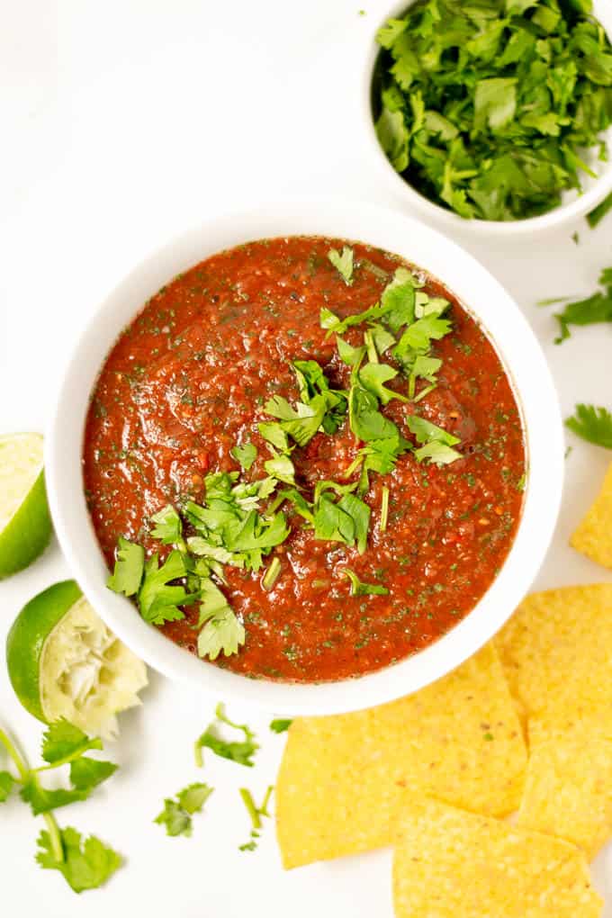 Overhead shot of a white bowl filled with fresh homemade restaurant style salsa