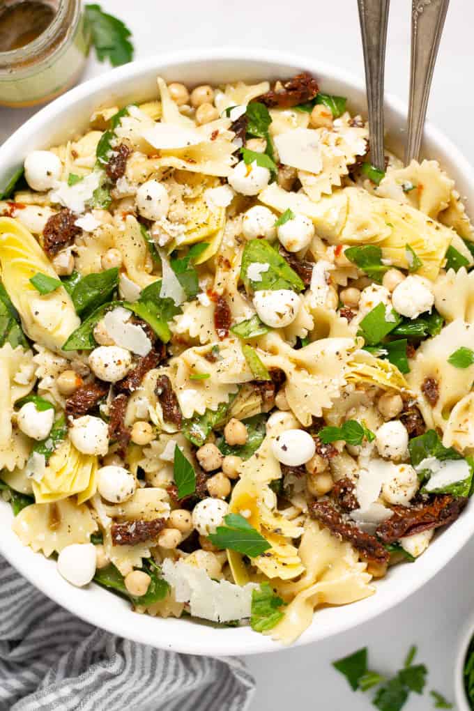 Overhead shot of a bowl of pasta salad garnished with fresh parsley