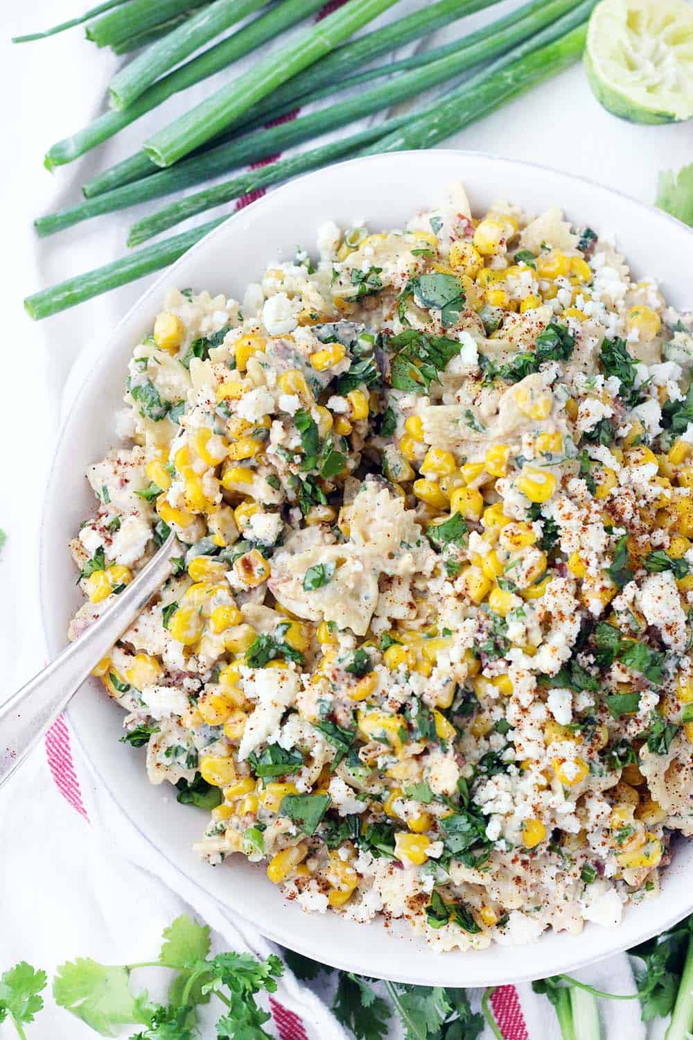 Overhead shot of Mexican corn salad garnished with fresh parsley and paprika