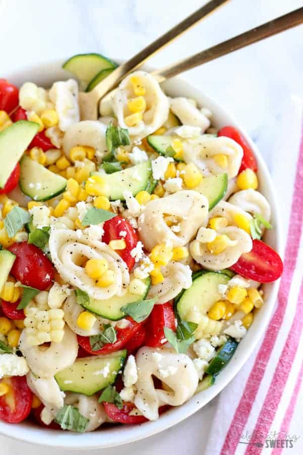 Overhead shot of tortellini salad with corn and tomato