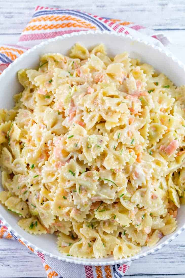 Overhead shot of a white bowl filled with smoke salmon pasta salad