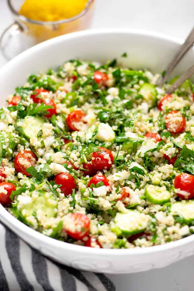 Close up shot of a white bowl filled with tabbouleh