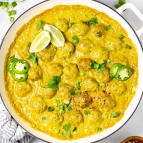 Overhead shot of a pan of curried pork meatballs garnished with fresh cilantro