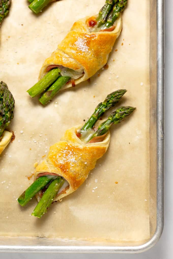 Close up overhead shot of a baked puff pastry bundle on a parchment covered baking sheet 