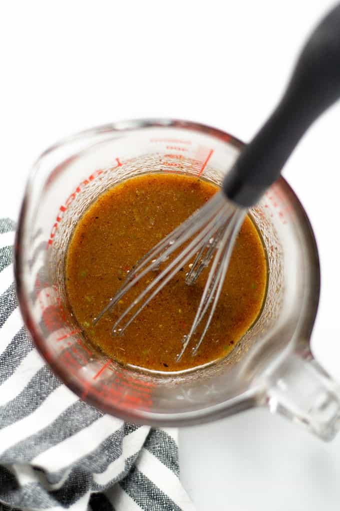 Overhead shot of a measuring cup filled with chicken marinade
