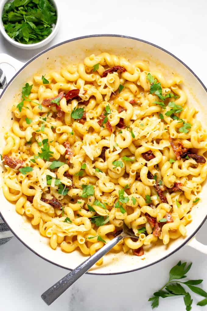 Overhead shot of a pan filled with smoked gouda mac and cheese garnished with fresh parsley