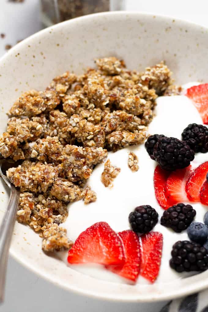 Close up shot of a bowl filled with rawnola yogurt and fresh berries