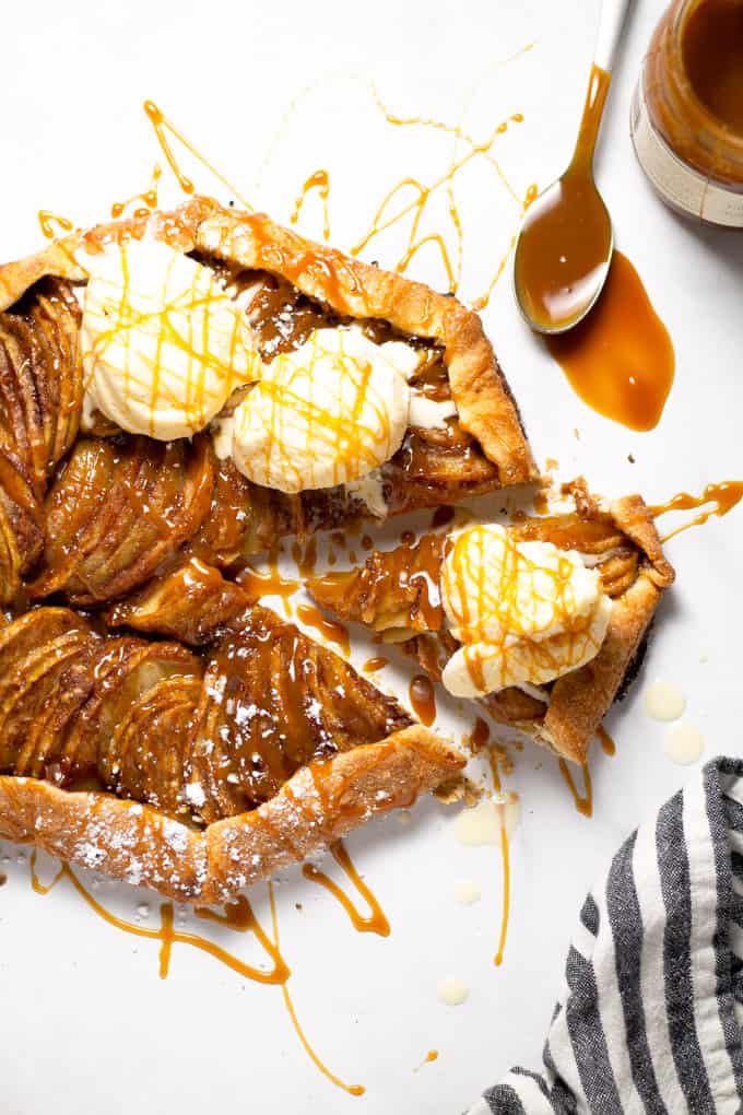 Overhead shot of an apple tart topped with caramel and ice cream