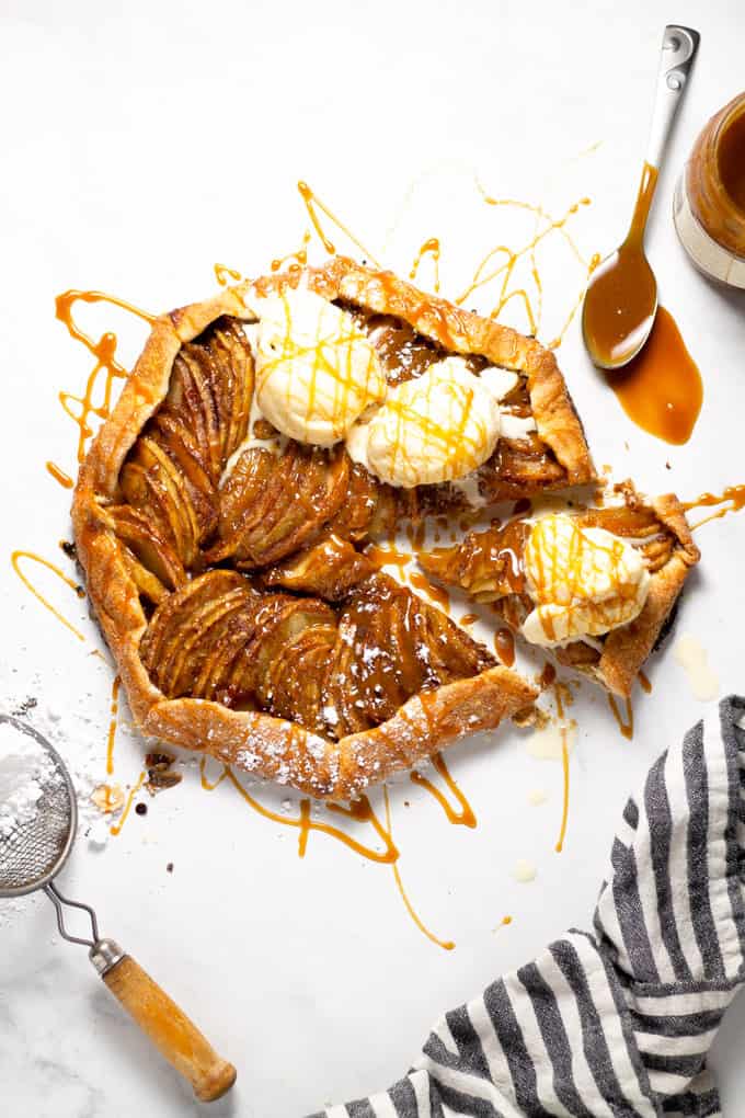 Overhead shot of an apple tart topped with caramel and ice cream