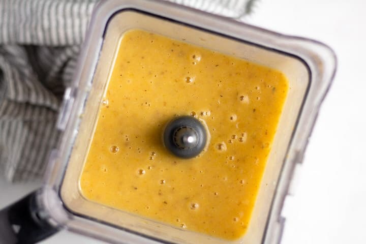 Overhead shot of a blender with creamy potato soup in it