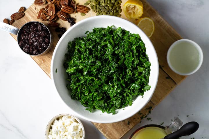 A large white bowl filled with fresh chopped massaged kale