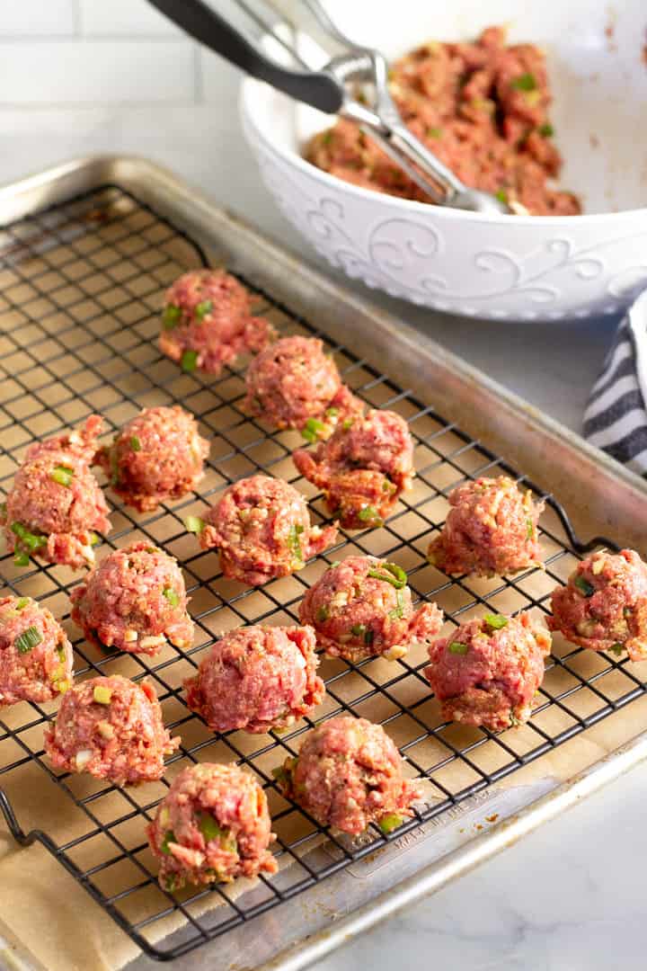 Baking sheet filled with Korean beef meatballs that are ready to be baked in the oven 