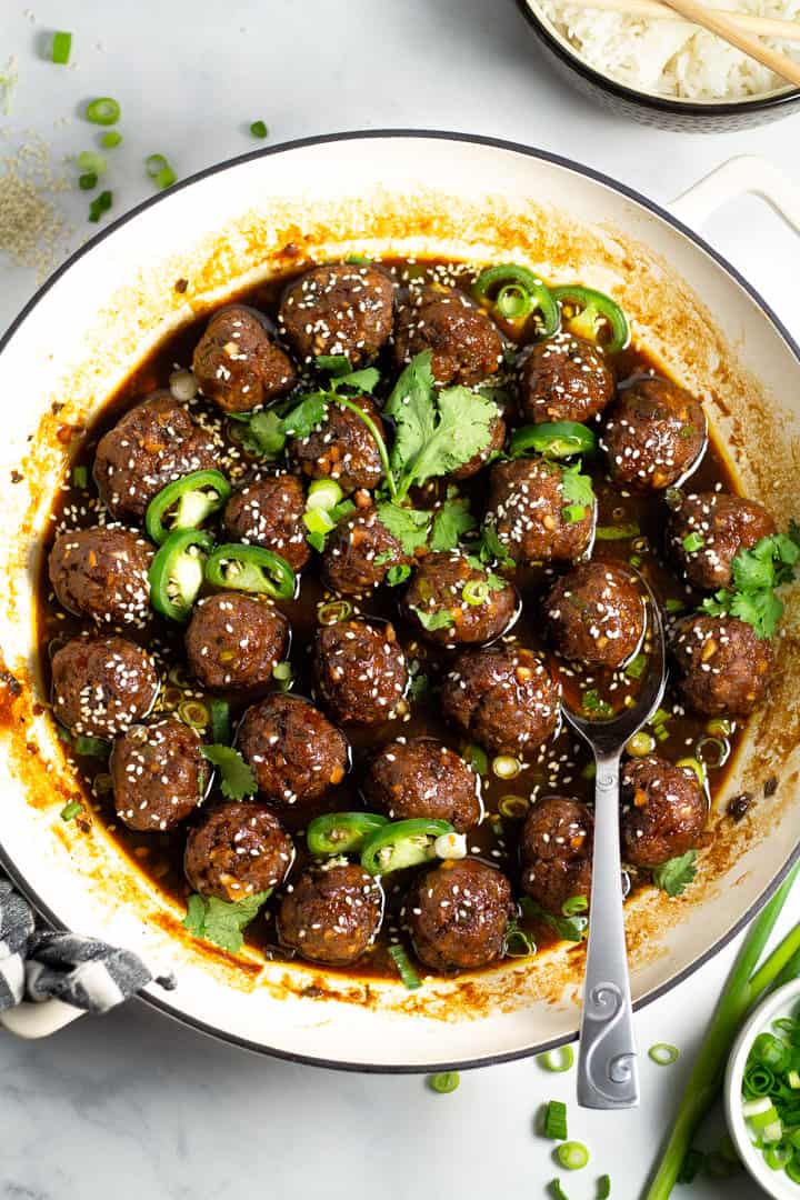 Overhead shot of a white pan filled with Korean beef meatballs garnished with fresh chopped cilantro 