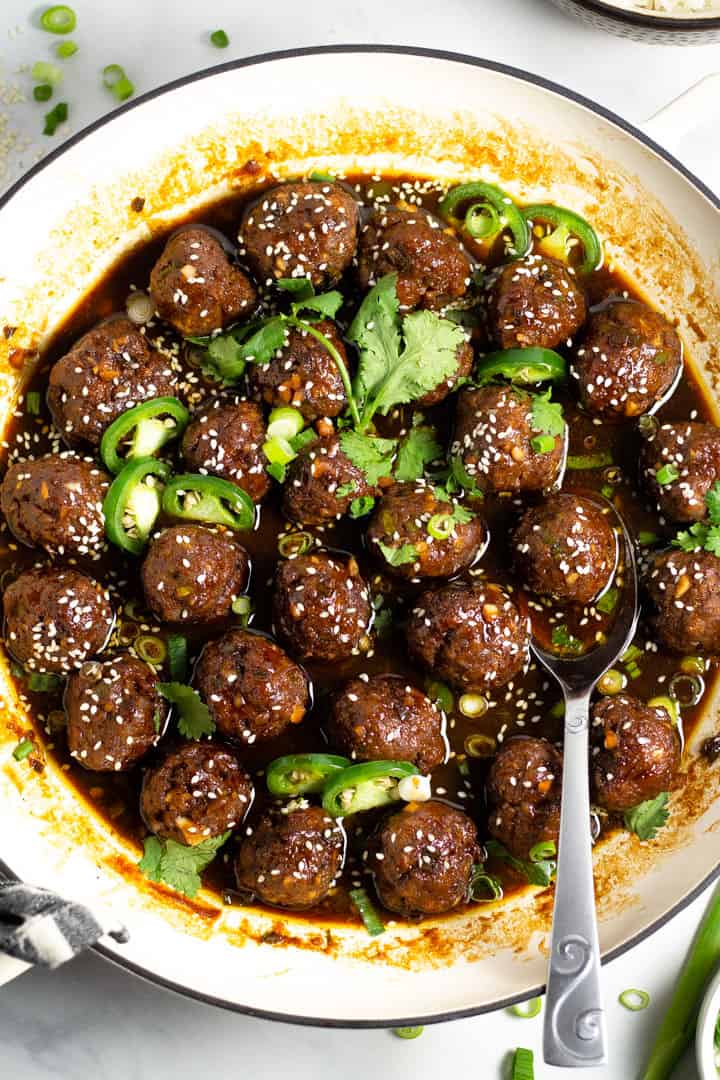 Overhead shot of a white pan filled with Korean beef meatballs garnished with fresh chopped cilantro 