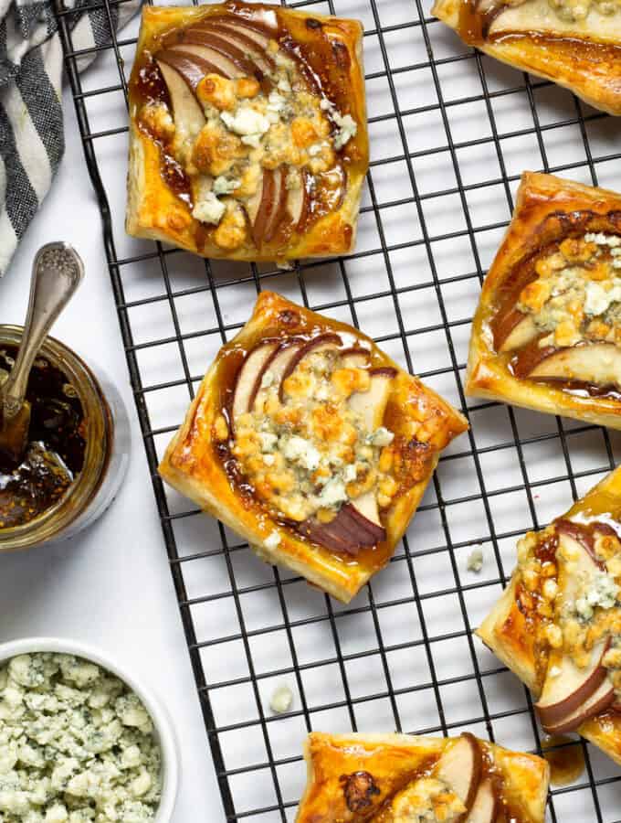 Overhead shot of pear tarts on a cooling rack
