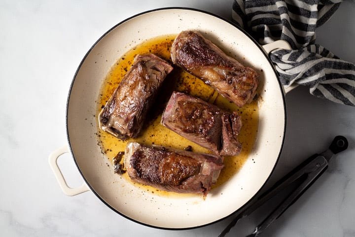 Large pot filled with seared short ribs