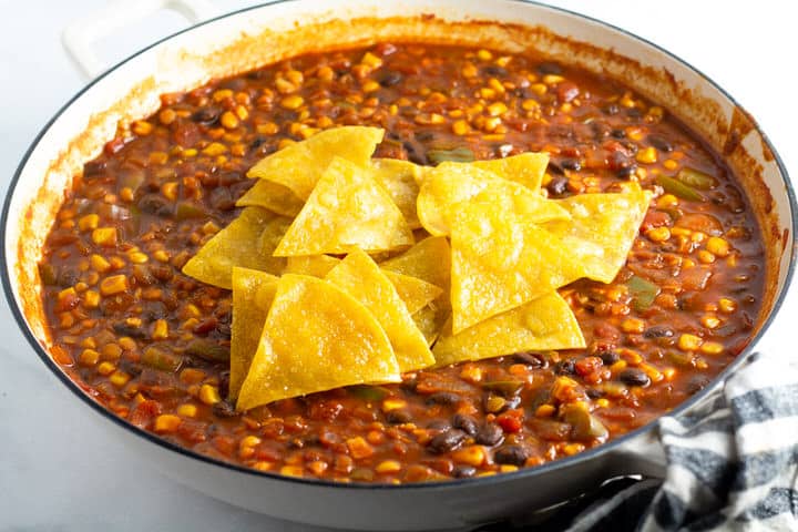 White saute pan filled with vegetarian one pan enchiladas
