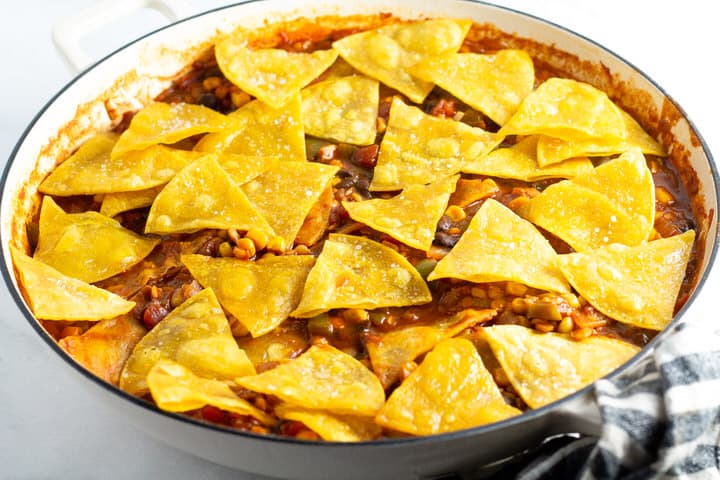 White saute pan filled with vegetarian one pan enchiladas