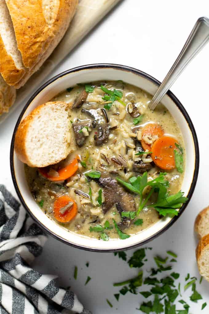 Overhead shot of a black and white bowl filled with homemade vegan wild rice soup