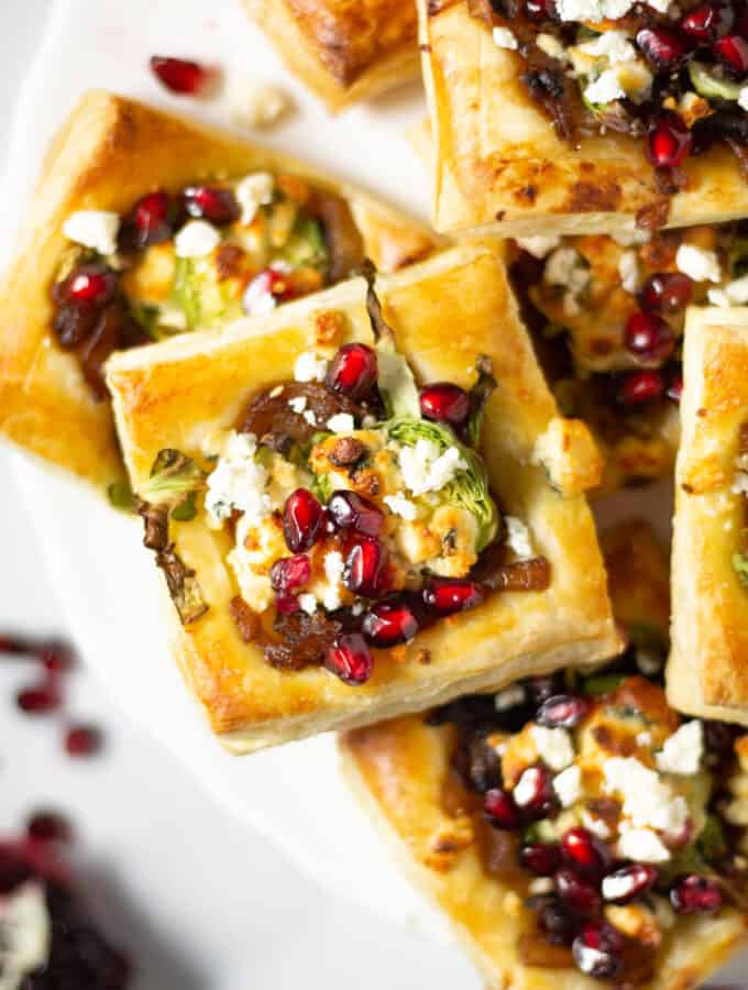 Overhead shot of a white platter of filled with brussels sprout tarts